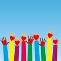 Raised human hands with red hearts. Concept of charity, volunteerism and donation. Children`s hands hold heart symbols. Purity an