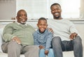 Raised with power, raised with pride. a grandparent bonding with his son and grandson on a sofa at home. Royalty Free Stock Photo