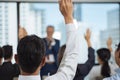 Raised up hands and arms of large group in seminar class room to agree or ask question to speaker at conference seminar meeting ro