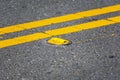 Raised yellow pavement marker separates opposing traffic lanes Royalty Free Stock Photo