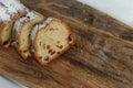 Raisin cake, dusted with icing sugar. Cupcake with raisins on a wooden board.