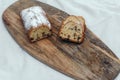 Raisin cake, dusted with icing sugar. Cupcake with raisins on a wooden board.
