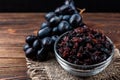 Raisin and grapes on dark wooden background Royalty Free Stock Photo