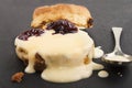 Raisin scone with fresh custard on slate