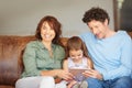 Raising the digital generation. a little girl and her parents using a digital tablet at home. Royalty Free Stock Photo