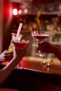 Raising glass in cocktail bar