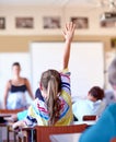Raising her hand...A young school girl raising her hand to ask a question. Royalty Free Stock Photo