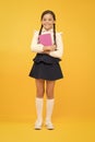 Raising independence. Schoolgirl wear school uniform. Knowledge day. Girl with copy book or workbook. Kid student ready Royalty Free Stock Photo
