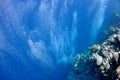 Raising underwater bubbles in the blue sea Royalty Free Stock Photo