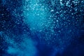 Raising underwater bubbles in the blue sea Royalty Free Stock Photo