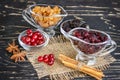 Raisins in a bowl, cranberries, cinnamon and anise on wooden ta Royalty Free Stock Photo