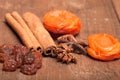 Raisins, cinnamon, anise and dried apricots lying on an old wood