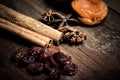 Raisins, cinnamon, anise and dried apricots lying on an old wood