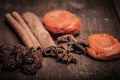 Raisins, cinnamon, anise and dried apricots lying on an old wood