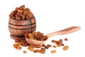 Raisins in a wooden bowl with spoon on white background. Selective focus Royalty Free Stock Photo