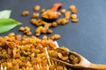 Raisins on a wooden spoon. Natural light. Selective focus. Close up on a black background. Top view, flat lay. copy Royalty Free Stock Photo