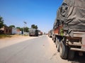 10.04.2020 - Rajasthan, India : fully loaded covered trucks loaded with raw factory material