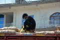 Man fixe potatoes bags on the top of a truck