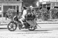 man with Mother and wife riding on scooter on the highway