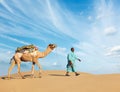 Cameleer camel driver with camels in Rajasthan, India