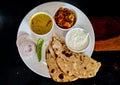 Rajasthani dish curry and sev Tomato with Indian bread naan Royalty Free Stock Photo