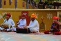 Rajasthani men dressed in traditional attire playin folk music