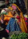 Rajasthani woman weighing vegetables in market