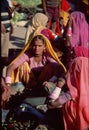 Rajasthani woman weighing vegetables in market