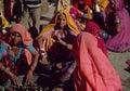 Rajasthani woman weighing vegetables in market