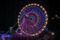 Rajkot, Gujarat, India, 06-09-2023, Starlit Spin: Mesmerizing Neon Ferris Wheel at Twilight