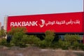 RAK Bank red sign in evening on a main road in the northern Emriates