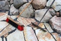 A rake and broom used on patio stones