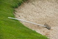 Rake in golf bunker Royalty Free Stock Photo