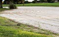 Rake next to golf course sand trap Royalty Free Stock Photo