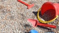 Rake shovel and bucket child on playground gravel