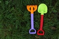 Rake and shovel for children on green grass Royalty Free Stock Photo