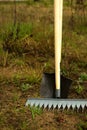 Rake and shovel is inserted into the ground for planting in the spring. Springtime, garden plants, working on a plot of land, Royalty Free Stock Photo