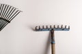 Rakes on white background, tool to sweep autumn leaves