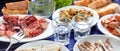 Raki, ouzo glasses and seafood appetizers background, closeup view