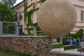 Rakovnik, Czech Republic - July 2, 2022 - the statue of a man rolls a heavy stone up the mountainside on a sunny summer afternoon