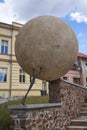 Rakovnik, Czech Republic - July 2, 2022 - the statue of a man rolls a heavy stone up the mountainside on a sunny summer afternoon