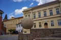 Rakovnik, Czech Republic - July 2, 2022 - the statue of a man rolls a heavy stone up the mountainside on a sunny summer afternoon