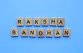 Raksha Bandhan, a minimalistic banner with an inscription in wooden letters Royalty Free Stock Photo