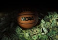 Raleigh, NC - USA - 04-15-2024: An NCAA basketball surrounded by money Royalty Free Stock Photo