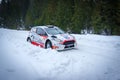 Rally car on Levoca Rally driving on snow in a forest in Torysky, Slovakia.