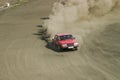 Rally car skidding on a dusty gravel road Royalty Free Stock Photo