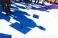 A rally of dissatisfied citizens protesting on the street. Silhouettes of people with banners are reflected on the sidewalk made