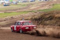 Rally off-road car make a turn with the clouds and splashes of sand, gravel and dust during rally championship