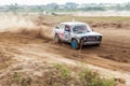 Rally off-road car make a turn with the clouds and splashes of sand, gravel and dust during rally championship