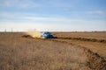 a rally sport car driving on the drit gravel race, fast speed with mud splash